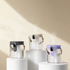Three transparent water bottles with black, silver, and purple lids on white stands against a beige background.
Dual spray humidifier with nano fine mist technology and dual outlet design