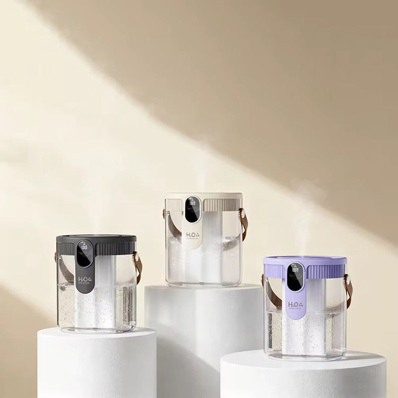 Three transparent water bottles with black, silver, and purple lids on white stands against a beige background.
Dual spray humidifier with nano fine mist technology and dual outlet design