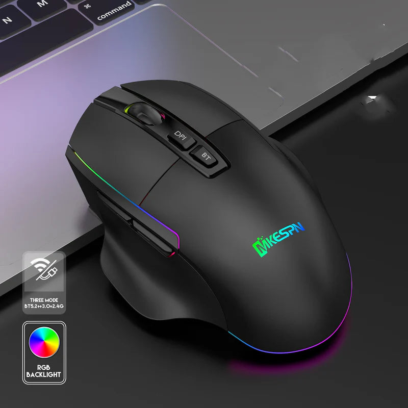 Black gaming mouse with RGB backlighting on a desk next to a laptop