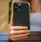 Person holding a Dual-Tone Fabric & PU Leather Case for iPhone 14 Pro Max | 13,15 & 16 Pro Max with a textured finish